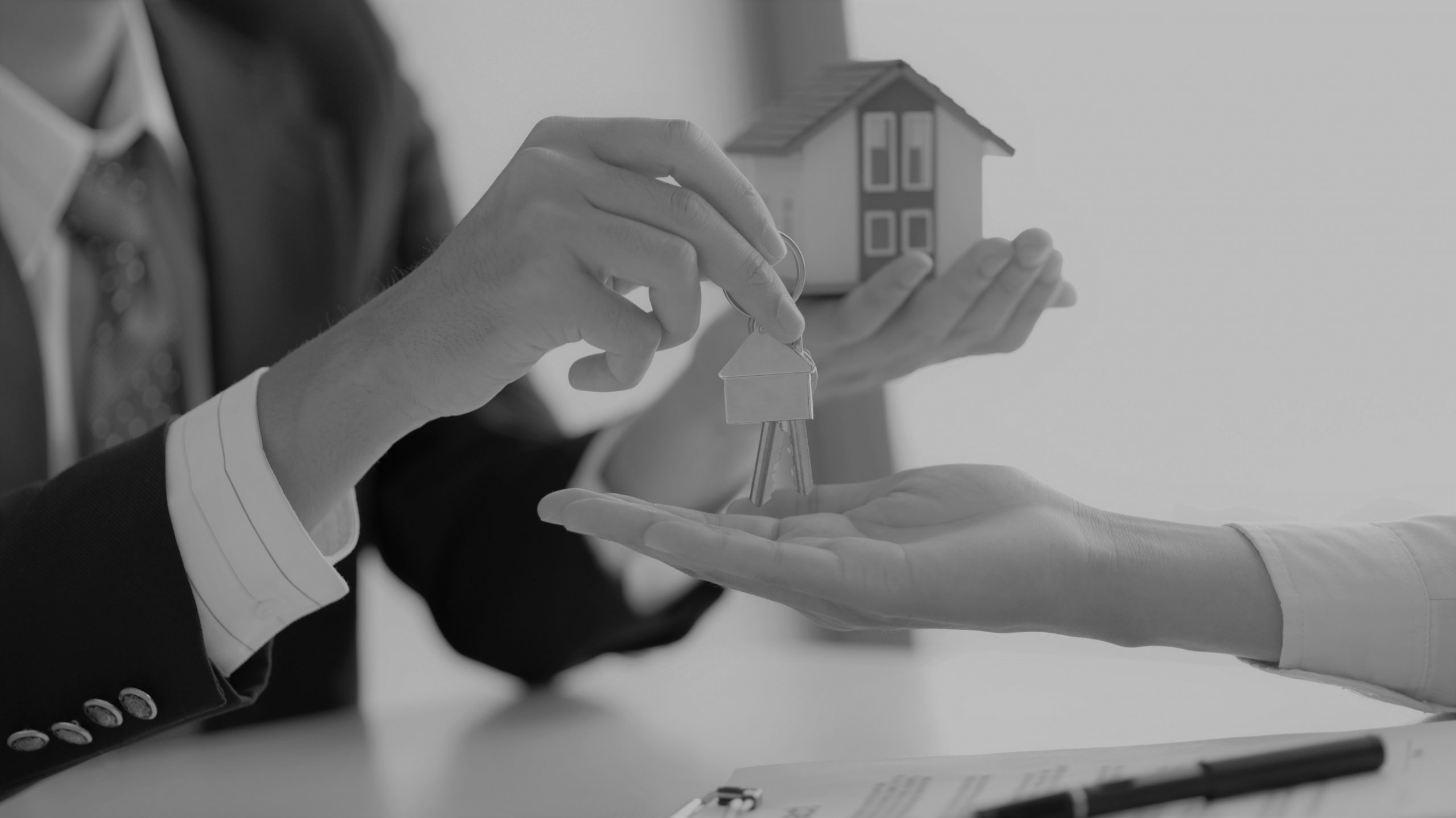 Close-up shot of Real estate broker delivers building keys to clients.